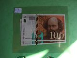 a picture of a paper with a picture of a man on it next to a pair of scissors