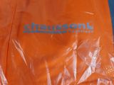 a plastic bag with a logo on it sitting on a table