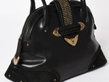 black leather handbag with gold accents and chain handles