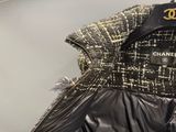 black and gold chanel jacket on a hanger in a clothing store