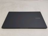a black laptop sitting on a white surface