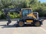 a yellow and black construction vehicle parked in a parking lot