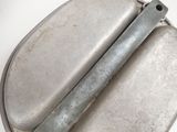 a metal object that is sitting on a white surface