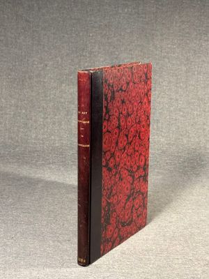a red book sitting on top of a table next to a gray surface