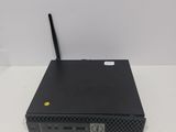 a close up of a small black device on a white surface