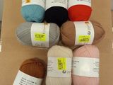 several balls of yarn sitting on top of a cardboard box