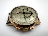 a close up of a watch on a white surface