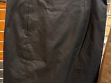 black leather skirt hanging on a rack in a store