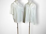 pair of mannequins wearing white shirts and red berets