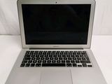 a silver laptop computer sitting on a white surface
