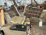 a pile of junk in a garage with a lot of tools