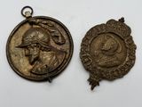 two bronze medallions of a man and a woman