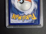 a pokemon card in a plastic holder on a table