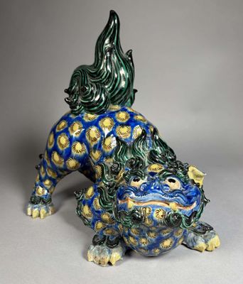 an image of a blue and green statue of a dog