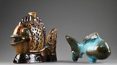 two figurines of a fish and a fish on a table
