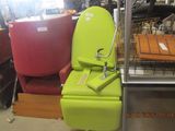 a green toilet that is sitting in the middle of a room