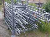 a pile of metal pipes sitting in the middle of a field