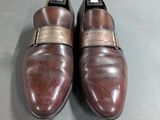 men ' s brown leather dress shoes with gold buckles on them