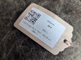 a label on the back of a brown teddy bear
