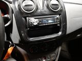 a car dashboard with a car radio and a steering wheel