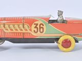 a toy car with a dog in it on a white surface