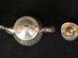 three silver spoons are lined up on a black surface