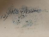 a close up of a vase with writing on it