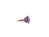 a close up of a ring with a purple stone in it
