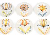 six plates with different designs of flowers on them on a white surface