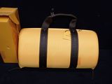 a yellow duffel bag sitting next to a yellow box