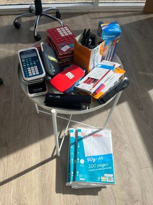 a small table with a lot of office supplies on it