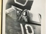 a black and white photo of a man sitting in a plane
