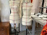 three mannequins on a table in a room
