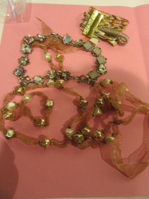 a pink piece of paper with a bunch of jewelry on it