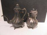 une théière en argent et une théière en argent posées sur une table