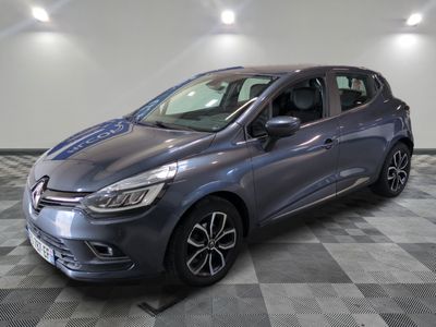 the grey car is parked on a checkered tile floor