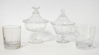 three glasses and a vase on a white surface