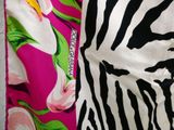 zebra print fabric with pink and green flowers on a white background
