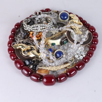 a picture of a pile of jewelry on a white surface