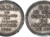 a close up of a silver coin with writing on it