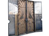 a large metal gate with a decorative design on it