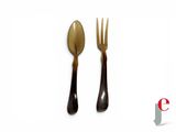 two forks and a spoon on a white surface