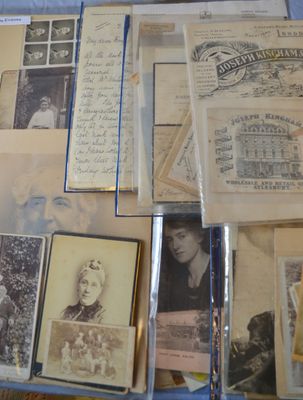 a lot of old photos and letters on a table