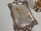 a silver plate and a silver spoon on a table