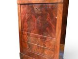 a wooden chest of drawers with a marble top