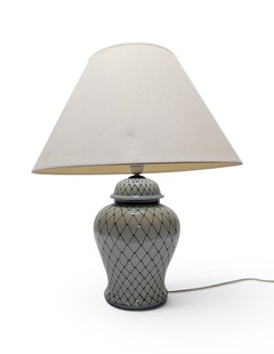 a lamp that is sitting on a table with a white shade on it