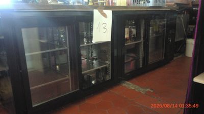 a glass door refrigerator with bottles on it in a store