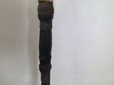 an old wooden stick with a carved head on it sitting on a table
