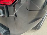 a close up of a car ' s tail light on the side of the road