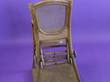 a small wooden chair with wheels on a purple background
